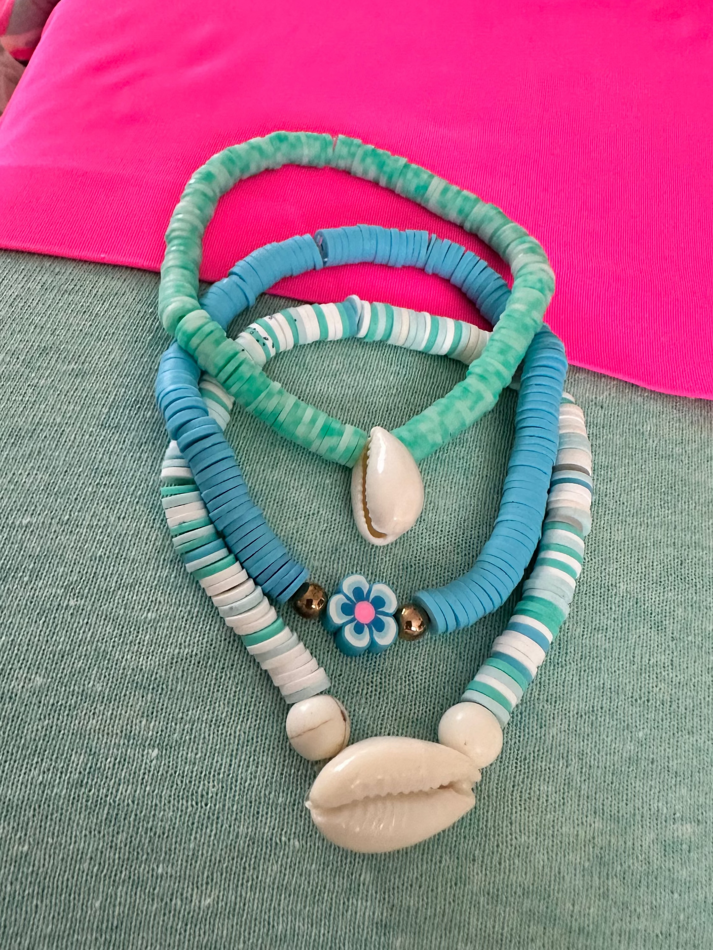 Set of three beach-inspired bracelets with seashell charms  